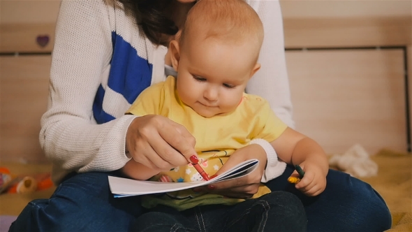 Mother And Baby Daughter Together Paint a Kid Pencils