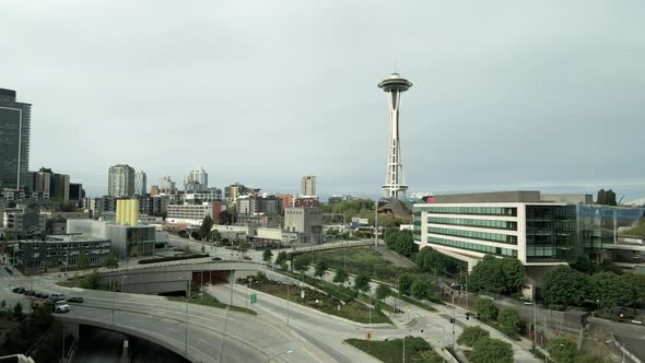 Pull back and reveal busy roads winding through iconic downtown Seattle, Washington, aerial