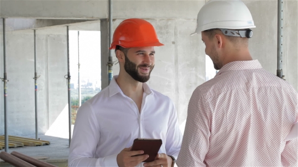 Construction Engineer Holds Digital Tablet In His Hands