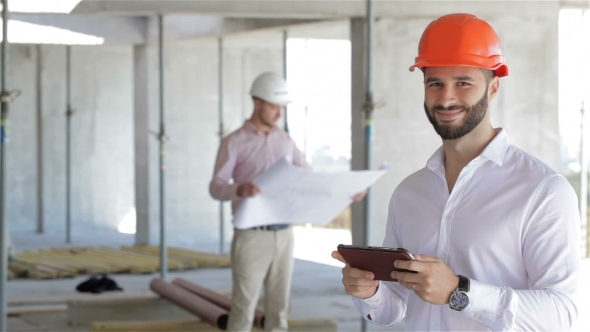Architector Looks At The Screen Of Digital Tablet