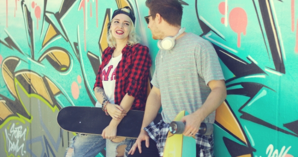 Trendy Modern Urban Couple Chatting At Skate Park