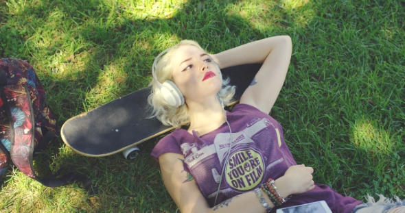Young Blond Woman Relaxing Listening To Music