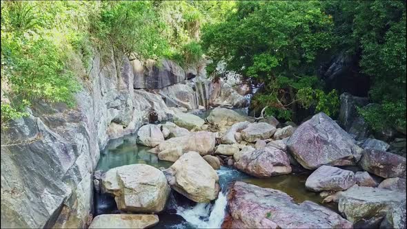 Drone View Mountain River Runs Among Boulders and Trees