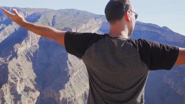 Young Foreign Male Tourist Enjoying the View of Wadi Ghul Aka Grand Canyon of Oman in Jebel Shams