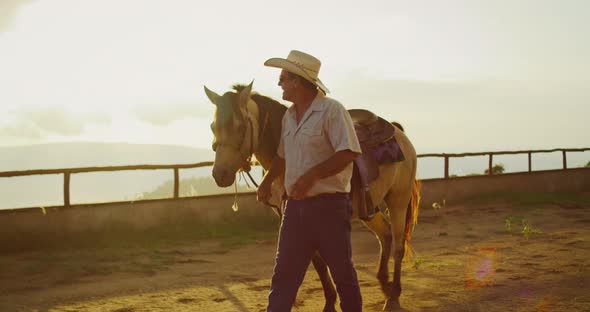 Cowboy Walking with his Horse