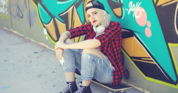 Trendy Young Urban Woman Waiting On Her Skateboard