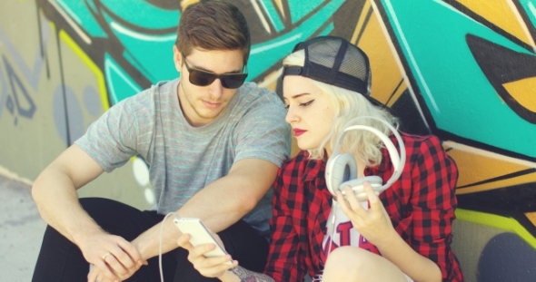 Fun Young Hipster Couple Listening To Music