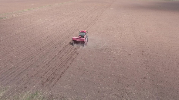 Aerial Of Tractor On Harvest Field