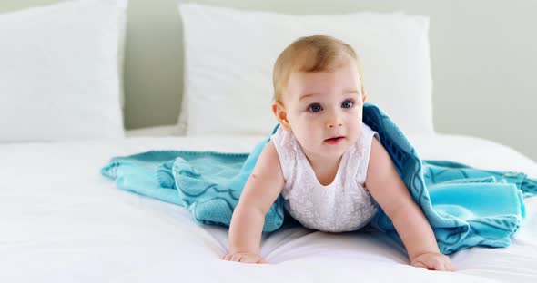 Cute smiling baby girl on bed