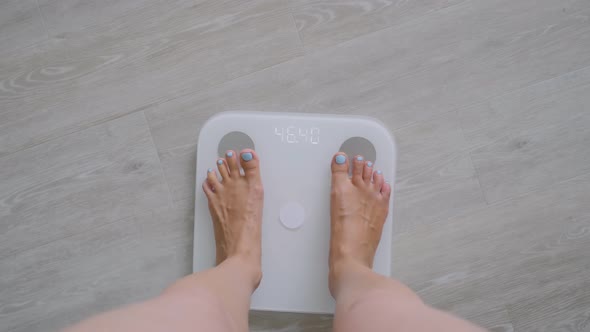 Female Bare Feet Stepping on Digital Floor Scales  Woman Weighing Herself