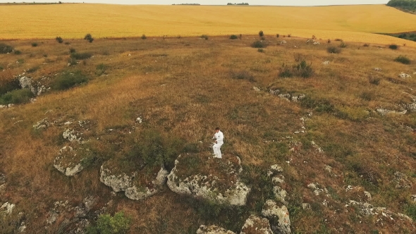 Aerial View Of Boy Exercising On The Rock