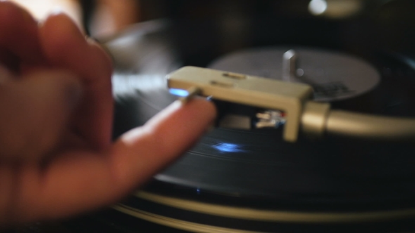 Turntable Playing Music With Hand With Backlight . Oldschool Hipster Concept.