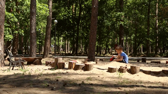 A Boy Plays in the Sandbox