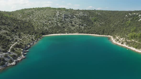 Aerial panorama shot of Luca beach, Croatia. Slow dolly in with drone. Small lagoon with ship wreck.