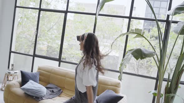Slow Movement of Happy Young Woman with Headphones Dancing Having Fun in Apartment
