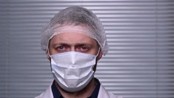 Close-up of male doctor in uniform looking at the camera. Coronavirus epidemic