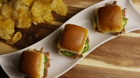 Rotating shot of delicious pulled pork sliders - BBQ 