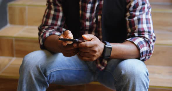 Senior male executive using mobile phone in office