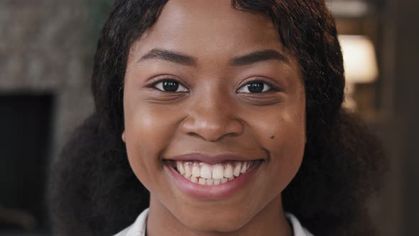 Extreme Close Up Female Face with Perfect Skin Healthy Millennial African Woman Looking at Camera