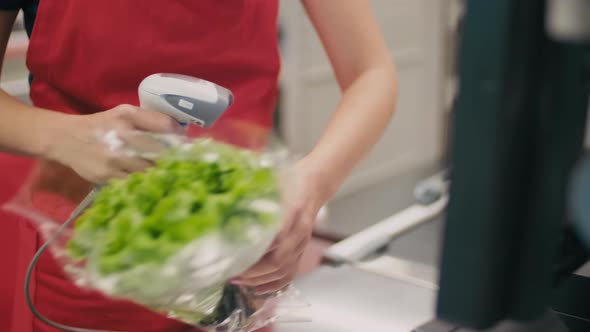 Cashier Scanning Products At Checkout