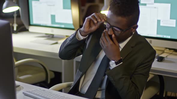Tired Black Businessman Working Late