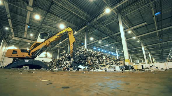 Garbage, Trash, Waste Recycling Factory. Indoors Dumping Site and a Loader Relocating Garbage