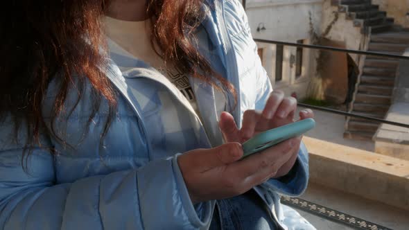 Female Hands Holding Mobile Phone Touching Screen