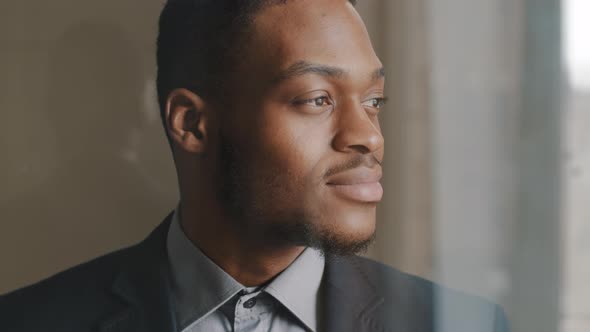 Portrait of Afro American Ethnic Business Man Entrepreneur Executive Standing in Profile Looking Out