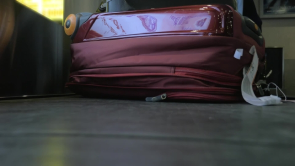 Suitcase On Luggage Conveyor Belt At Airport