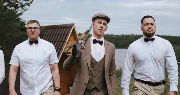 Group of Three Men Friends Gangsters Central Man Carries a Gun on His Shoulder