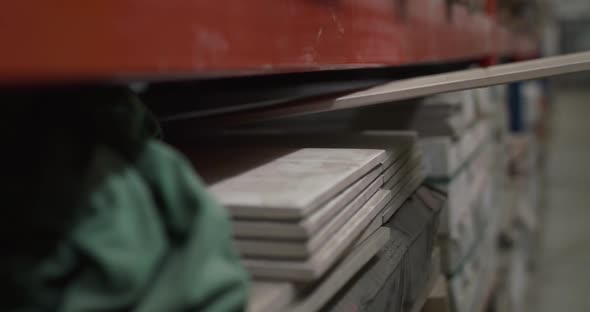 Male Hands Checks a Tiles on a Building Warehouse