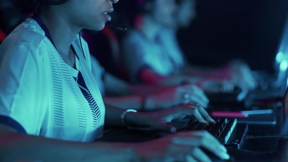 Esports Female Gamer Plays a Video Game Closeup View of Hands on the Keyboard Blue Neon Light Game