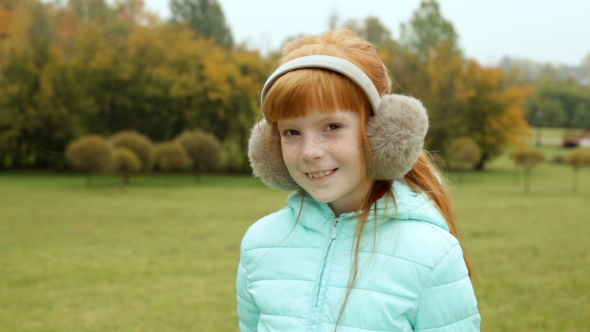 Ginger Girl In The Earmuffs Smiling