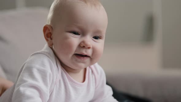 Close Up Nice Little Caucasian Newborn Baby Funny Smiling at Home at Clinic Child Girl Boy Small Kid