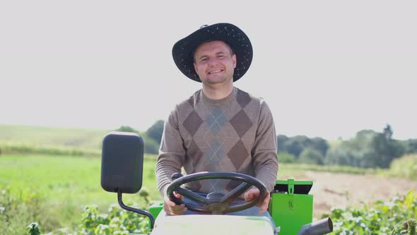 Portrait of a Farmer Sitting on a Tractor Smiling