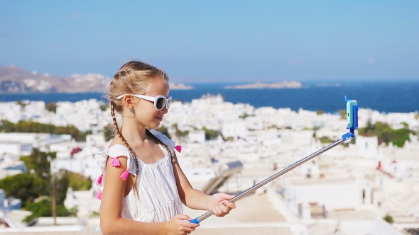 Adorable Little Girl Taking Selfie Photo Background Mykonos Town in Greece