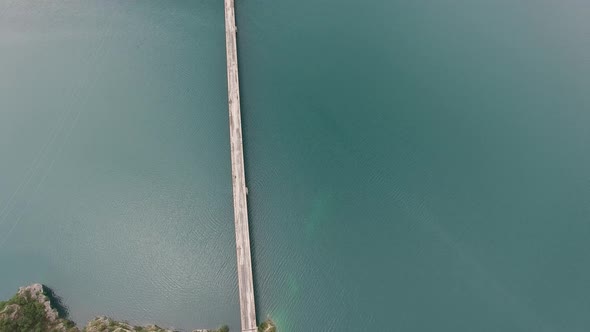 Top View Over the Automobile Bridge Over Lake Piva Between Rocky Mountains