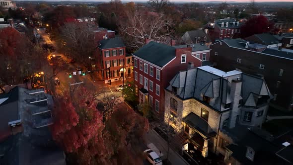 Aerial establishing shot of upscale residential homes in evening light. Darkness in urban city in US