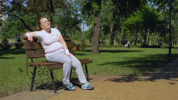 Fat Girl Sitting on Bench, Tired After Jogging but Goes on Running, Motivation