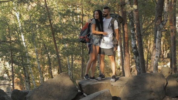 Hiking Couple Climbs On The Rock