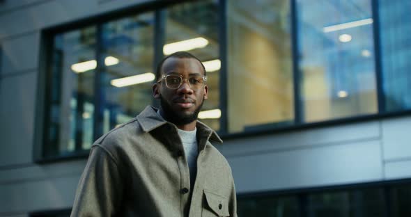 AfricanAmerican Man Smiling Looking at the Camera Near a Modern Building