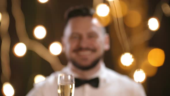 Portrait of Happy Man Toasting with Champagne