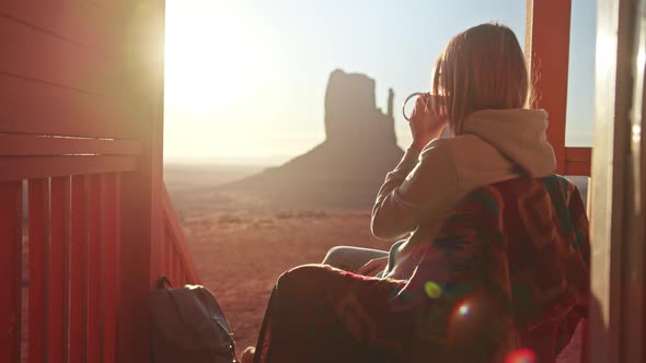 Woman Drinking Cup of Tea Relaxing on Cabin Terrace Nature Morning Sunrise