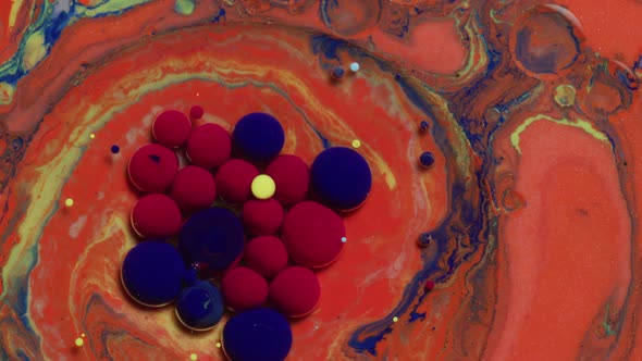 Abstract close up texture of oil with orange, blue, yellow and red paint alt