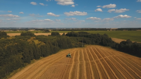 Aerial View Combine Harvesting a Field Of Wheat.