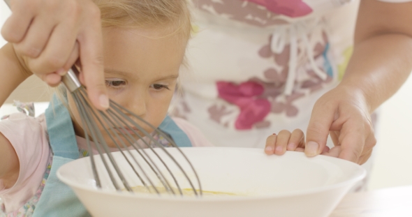 Little Girl Baking With Her Mother