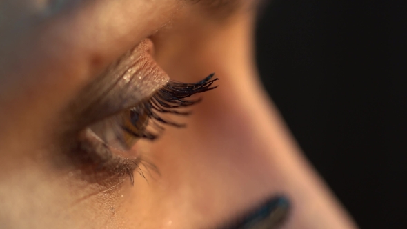 Make-Up Artist Applying Eyelash Makeup To Model's Eye