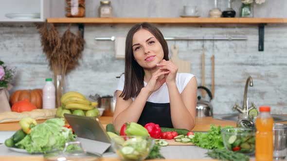 Charming Smiling Female Housewife Posing at Kitchen During Cooking Fresh Appetizing Vegetable Meal