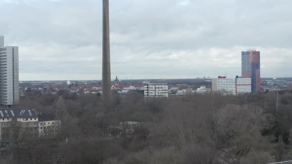 AERIAL: Low Shot Over Germany City Cologne with View of TV Tower on Cloudy Day 