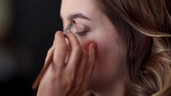 Makeup Artist Paints Eyelids on a Model Girl